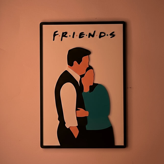 Framed illustration of a couple with 'FRIENDS' text on a wall.