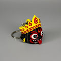 Keychain with a colorful mask design on a gray background