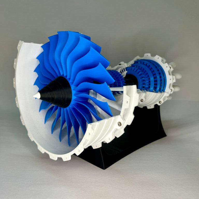 3D-printed model of a blue and white turbine on a gray background
