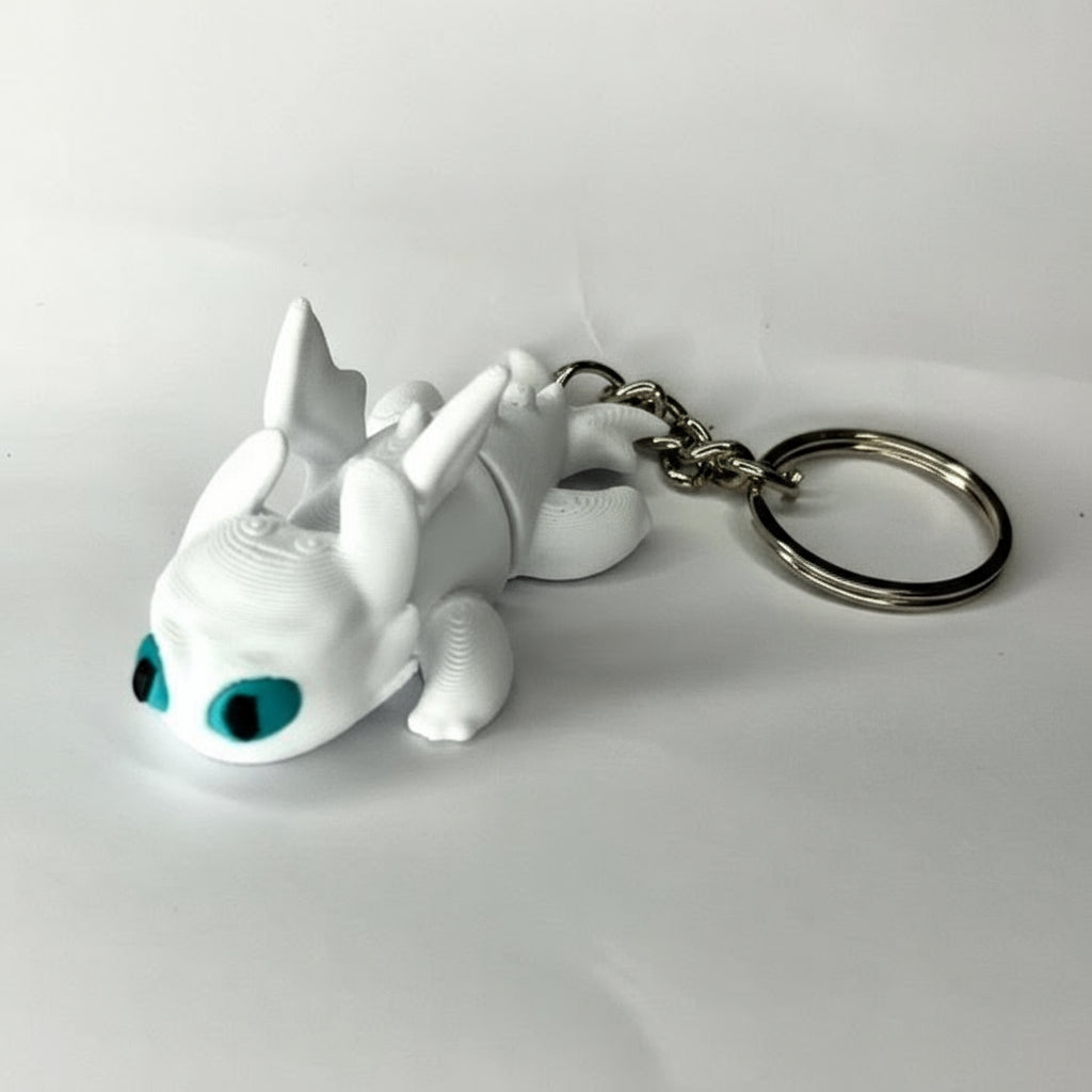 White dragon keychain with blue eyes on a white background