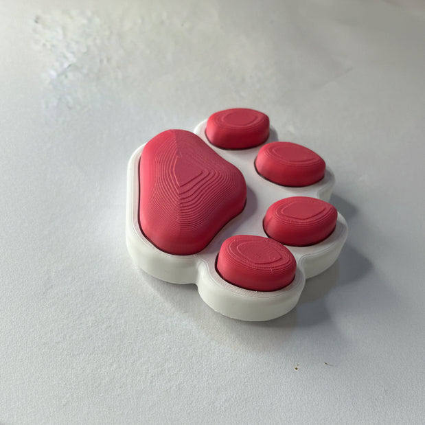 Red and white paw-shaped object on a light gray background